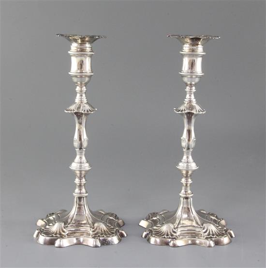 A pair of early George III cast silver candlesticks by Ebenezer Coker, gross 35 oz.